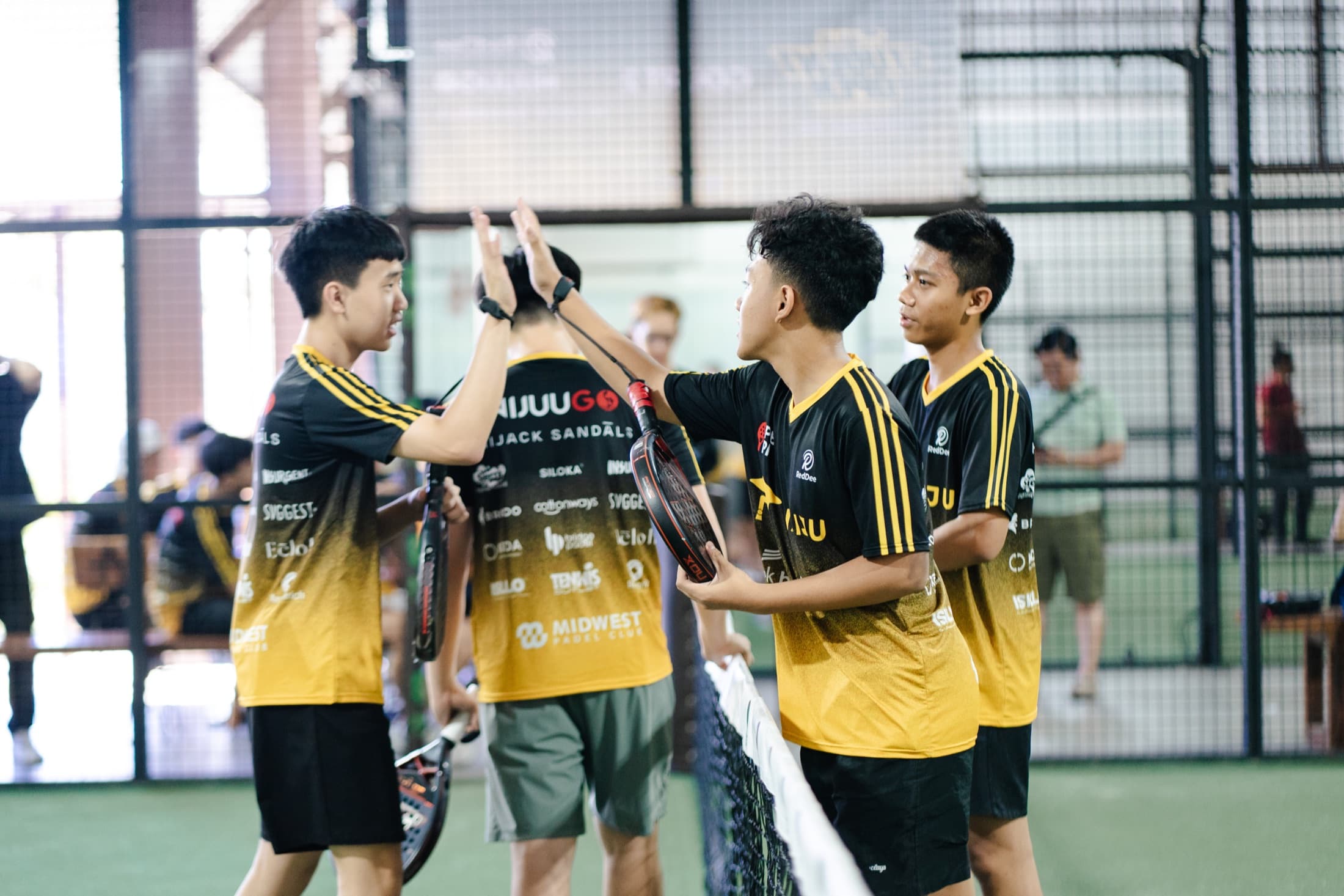 Naiju Student Open players exchanging a high five at the net