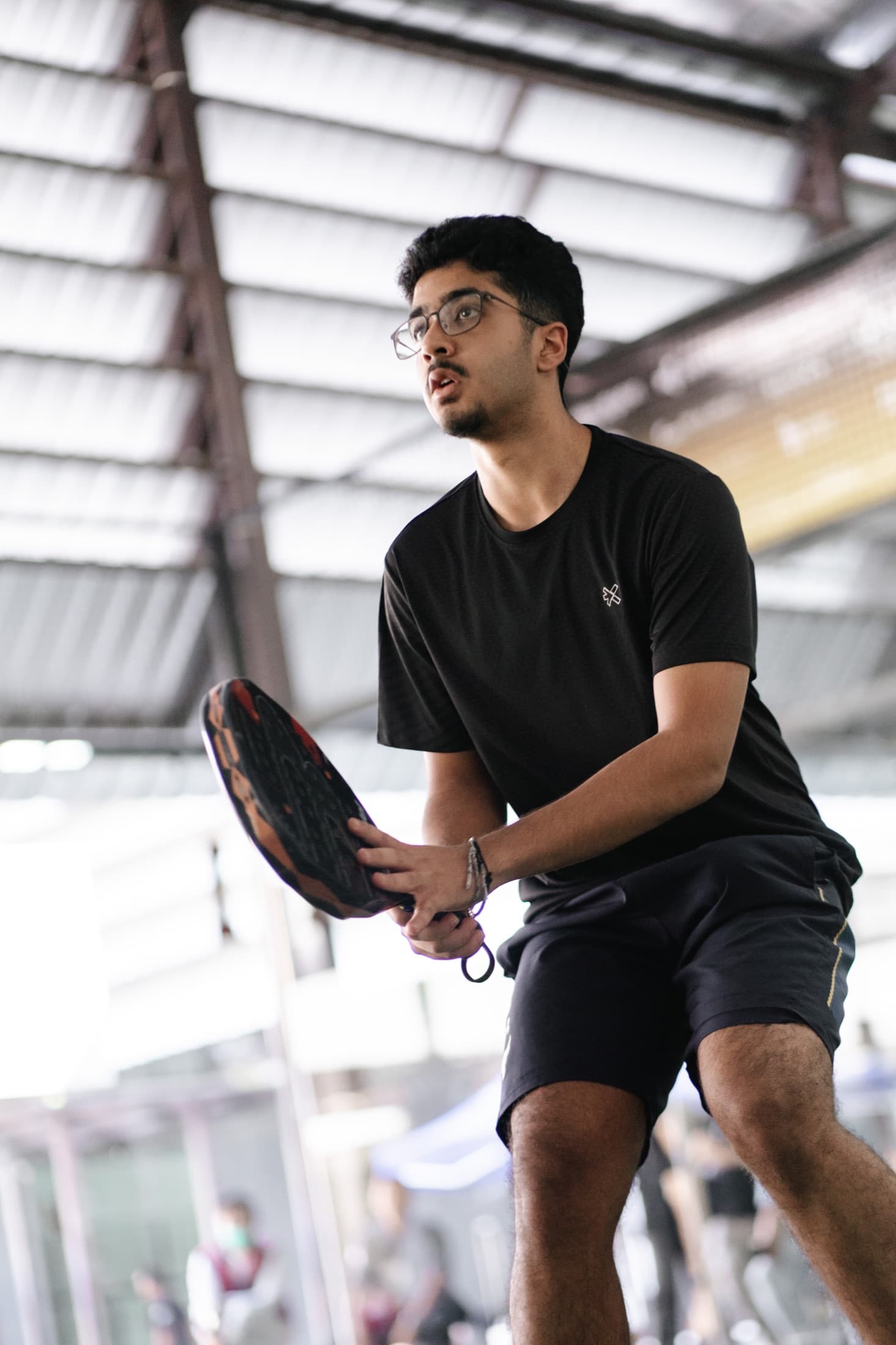Player preparing to receive serve at Naiju Student Open